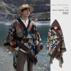 Close-up of ethnic hooded poncho with geometric knit pattern and tassel trim details