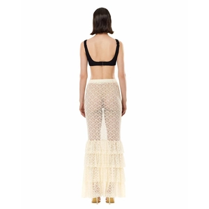 Rear view of model wearing a beige lace see-through maxi skirt with mermaid hemline