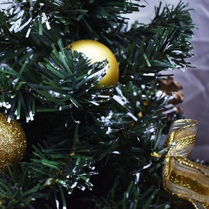 Mini artificial Christmas tree with snow needles, gold ornaments and mesh ribbon bow
