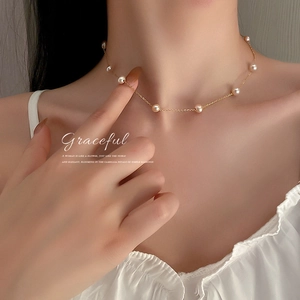 Graceful gold plated choker featuring dainty freshwater pearls on a minimalist chain
