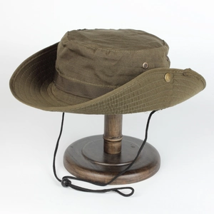 Detail of army green boonie hat with ripstop fabric and metal side vents on wooden stand