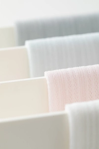 Close-up of thin mesh knit socks in pastel colors showing soft breathable texture