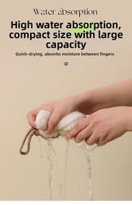 Detail showing hand wringing white coral fleece towel with water splash and fast drying