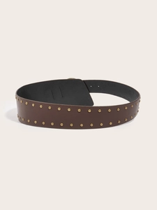 Detail view of brown wide punk belt with double rows of golden round rivets on the edges