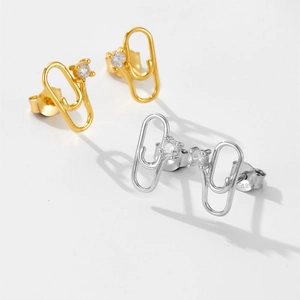 Detail of S925 sterling silver paperclip earrings with cubic zirconia and gold finish