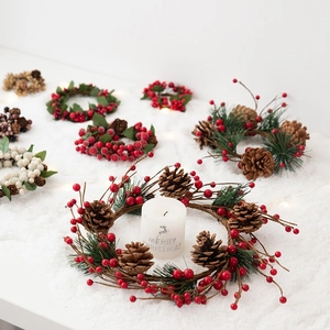 Christmas candle ring with red berries, pine cones and needles for festive table decor