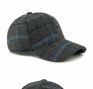 Close-up detail of the thick wool plaid texture and blue pattern on a retro baseball cap