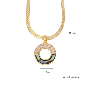 Detail view of gold necklace with abalone shell pendant showing 1.6cm diameter size