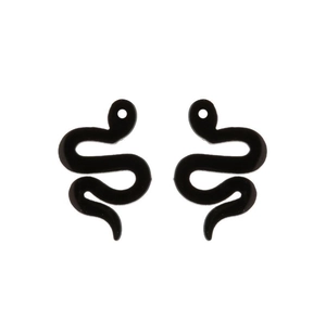 Detail of minimalist black S-shaped snake earrings with a sleek polished finish