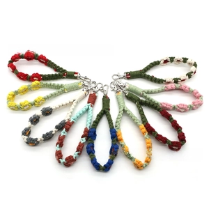 Macro shot of colorful handmade braided floral lanyards with silver lobster clasps