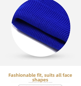 Detailed close-up of royal blue knitted beanie showing thick ribbed vertical texture