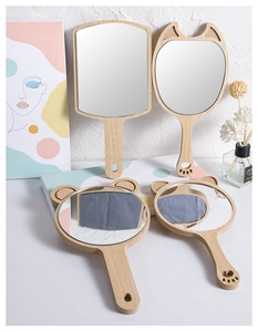 Collection of wooden handheld mirrors in various shapes with natural finish and handle
