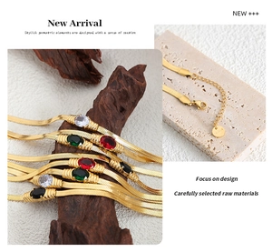 Detail of gold snake chain with colorful gemstones showing lobster clasp and extender