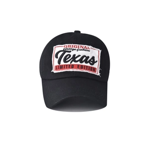 Close-up of Texas embroidery on washed cotton black baseball cap with vintage lettering