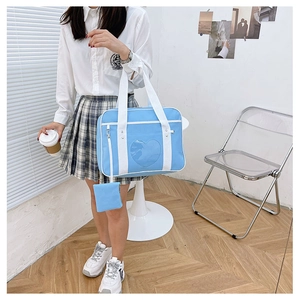 Detail of sky blue JK uniform ita bag with clear heart window and matching small coin purse