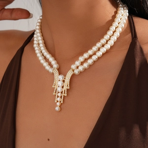 Close-up of elegant double-layer pearl necklace with a sparkling diamond pendant design