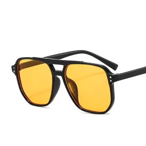 Classic black aviator sunglasses with yellow tinted lenses and silver rivet accents