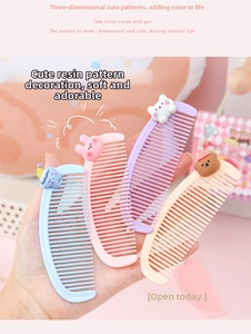 Close-up of four portable mini crescent combs with 3D resin cartoon animal charms
