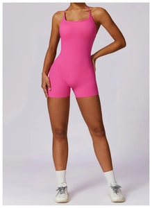 Hot pink athletic bodysuit with halter neck and slim fit shorts for fitness