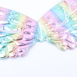 Close-up of holographic rainbow angel wings with embossed texture and elastic straps
