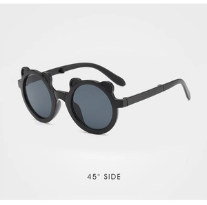 Detail view of foldable black bear-ear sunglasses for kids from a 45-degree angle