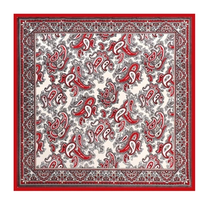 Detailed close-up of a square silk-like scarf with classic red and white paisley pattern