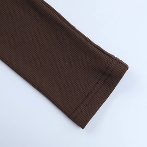 Detailed macro view of the ribbed knit cuff on a brown button-down cardigan sweater