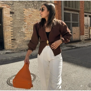 Minimalist brown V-neck knit cardigan with gold buttons and lantern sleeves on a model