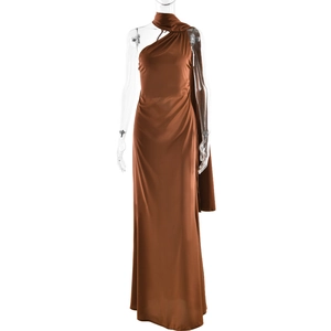 Detail of brown satin one-shoulder maxi dress with elegant flowing ribbon design