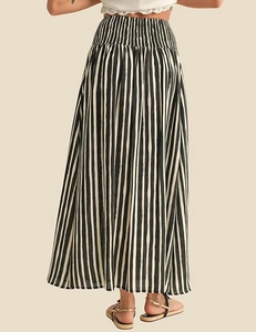 Rear view of long high-waisted skirt with black and white vertical stripes and elastic waist