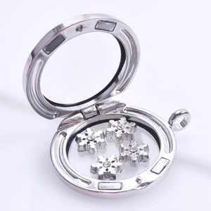 Detailed view of silver floating charm locket with delicate snowflake inserts inside