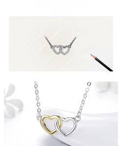 Detail of s925 silver interlocking double heart pendant with two-tone gold plating