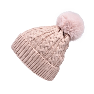 Detailed cable knit pattern on pink winter hat with large faux fur pom-pom detail