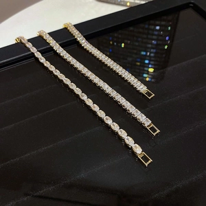 Detailed view of gold plated tennis bracelets featuring oval, emerald and princess cut stones