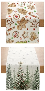 Detail of Christmas table runner with gingerbread and tree patterns on wooden surface