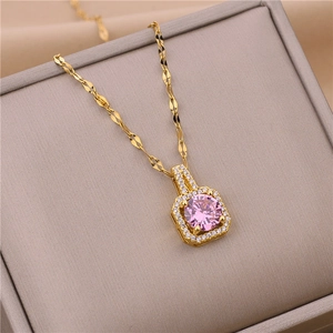 Golden square pendant necklace with a pink zircon stone in a jewelry box display