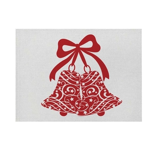 Detailed macro view of linen placemat featuring a festive red Christmas bell and bow