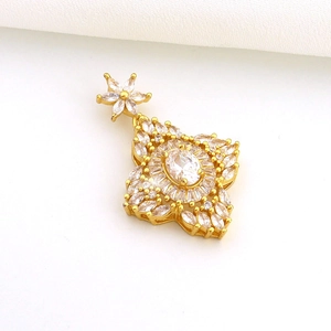 Detailed view of sun-shaped gold pendant with micro-set marquise zircon crystals