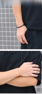 Minimalist black matte and gold mirror bracelets shown on male model with hoodie