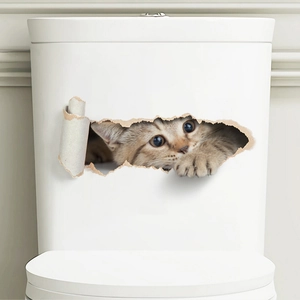 Close-up of a 3D cute brown tabby cat sticker peering through a hole on a white toilet