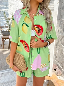Detail of vibrant green shirt and shorts set featuring lemon and checkered print