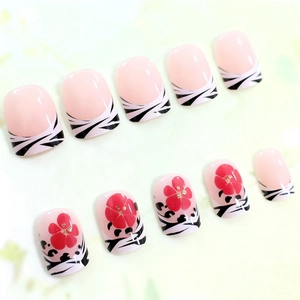Short square press-on nails with zebra stripes and red floral patterns in a glossy finish