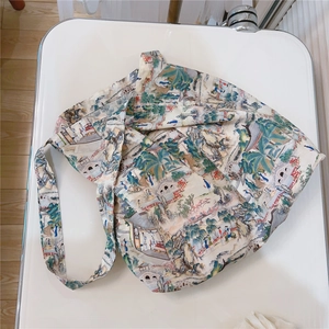 Detailed close-up of a cotton tote bag featuring traditional Chinese landscape art prints