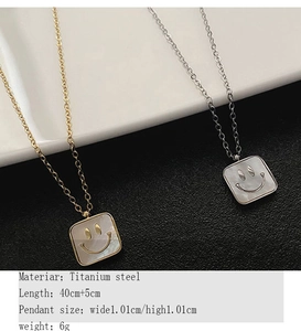 Detail view of square titanium steel necklaces with shell inlay and smiley face pendant