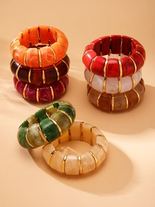 Macro detail of colorful marble resin bracelets with elegant golden metal spacers