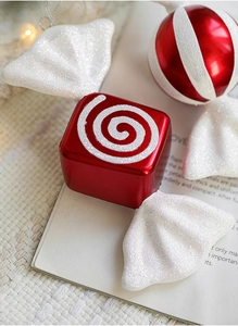 Detailed macro view of red and white striped Christmas candy ornaments with glitter accents