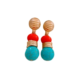 Vintage gold drop earrings with red beads and marble-pattern stones on white background