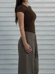 Side view of a slim fit short sleeve brown T-shirt with khaki joggers for women