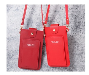 Detail of red and burgundy PU leather crossbody phone bags with metal buckle closures