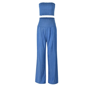 Detail of blue two-piece set featuring ruched bandeau top and high-waist wide-leg trousers